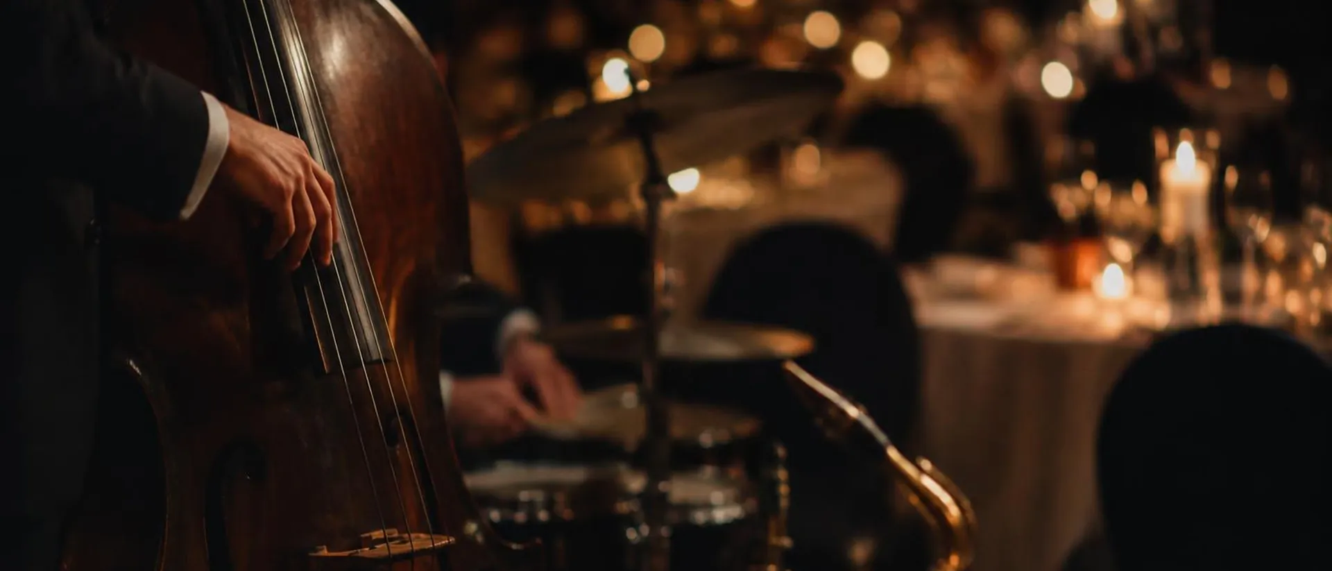 A double bass and softly focused jazz instruments in a dinner room.